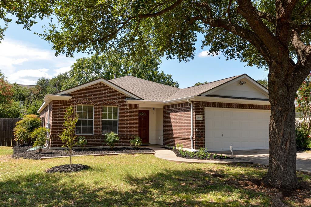 2109 Kimra Lane Cedar Park, TX 78613 - Photo 2 of 31 Single story home with brick siding, an attached garage, driveway, and roof with shingles
