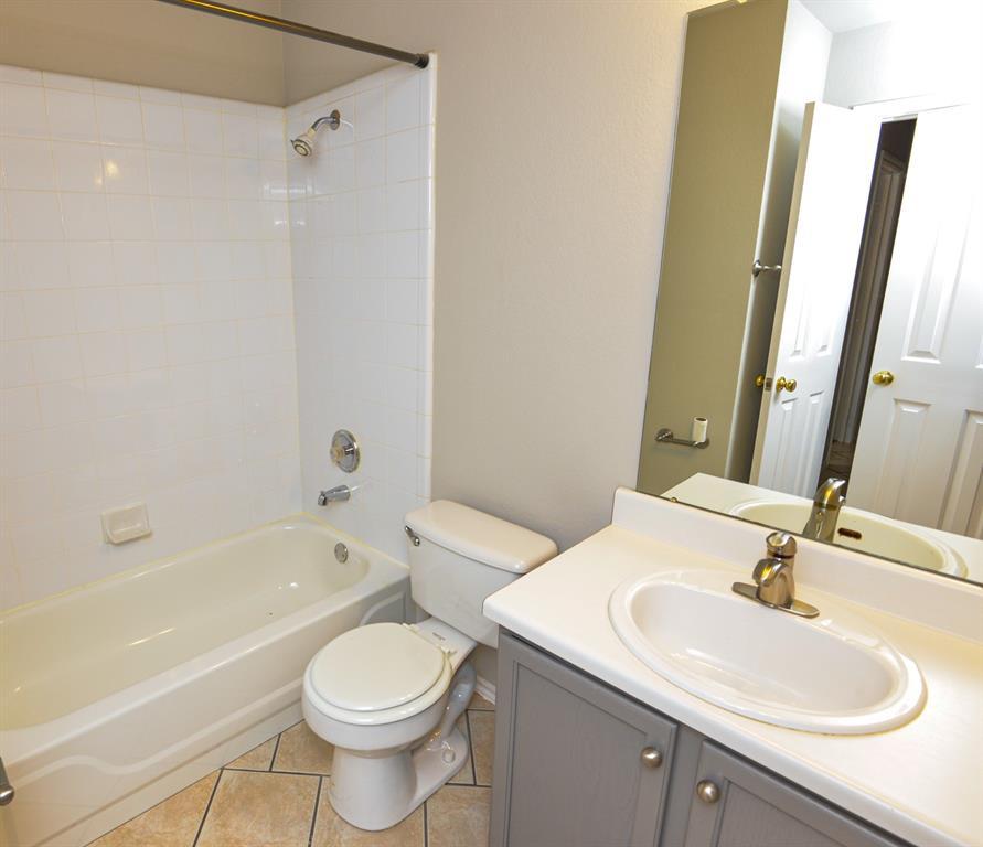 2109 Kimra Lane Cedar Park, TX 78613 - Photo 22 of 31 Full bathroom with bathing tub / shower combination, vanity, and light tile patterned floors