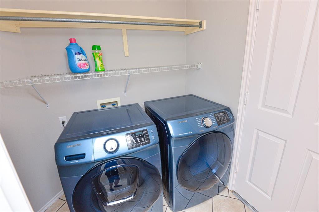 2109 Kimra Lane Cedar Park, TX 78613 - Photo 23 of 31 Laundry area with washing machine and dryer and light tile patterned floors