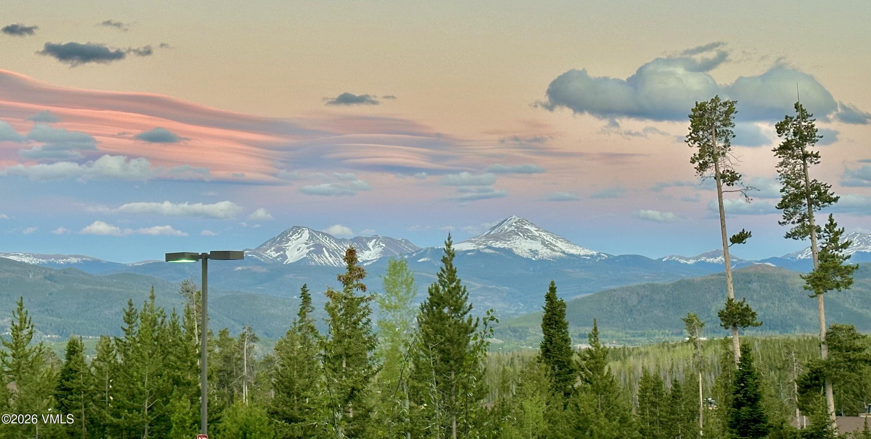 91300 Ryan Gulch Road, Unit 305 Silverthorne, CO 80498 - Photo 2 of 46 a view of a lake with a yard
