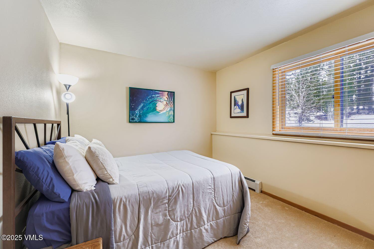 91300 Ryan Gulch Road, Unit 305 Silverthorne, CO 80498 - Photo 25 of 46 a bedroom with a bed and a window