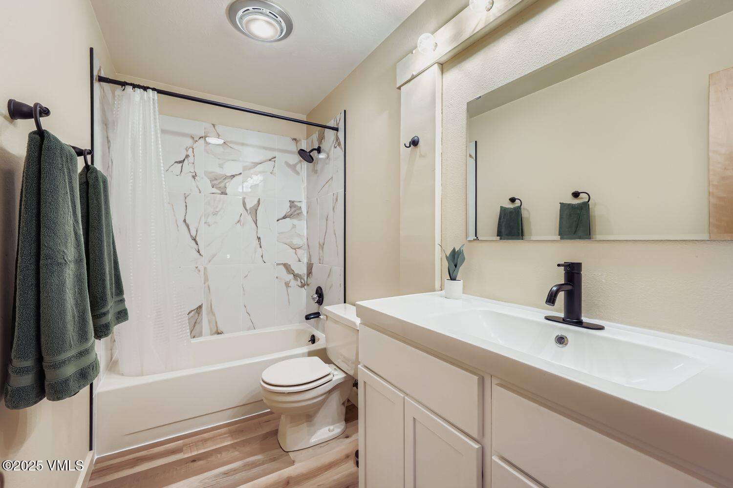 91300 Ryan Gulch Road, Unit 305 Silverthorne, CO 80498 - Photo 28 of 46 a bathroom with a bathtub shower sink vanity and toilet