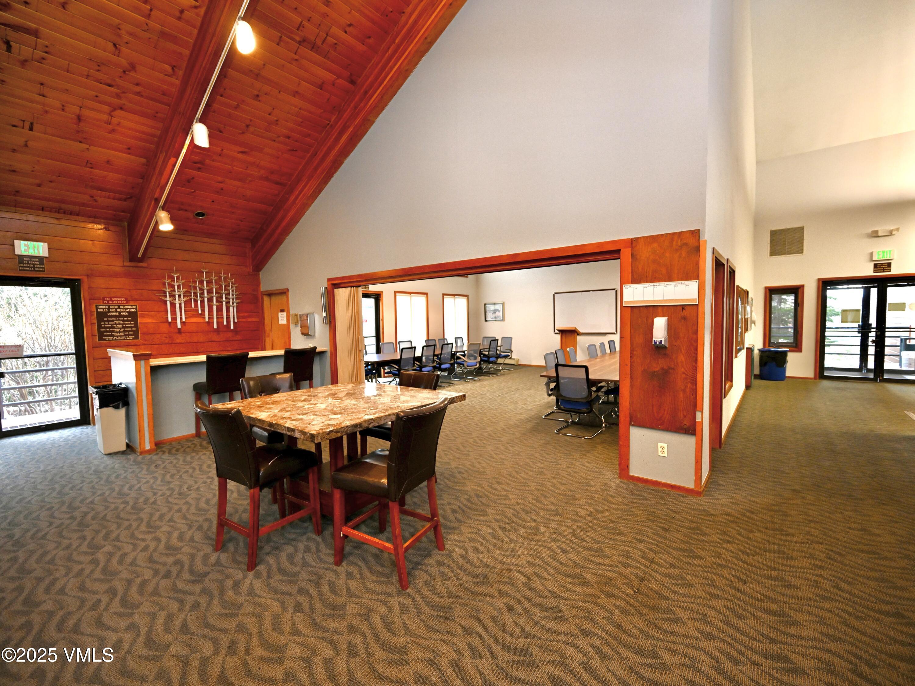 91300 Ryan Gulch Road, Unit 305 Silverthorne, CO 80498 - Photo 39 of 46 a dining room with furniture and a table