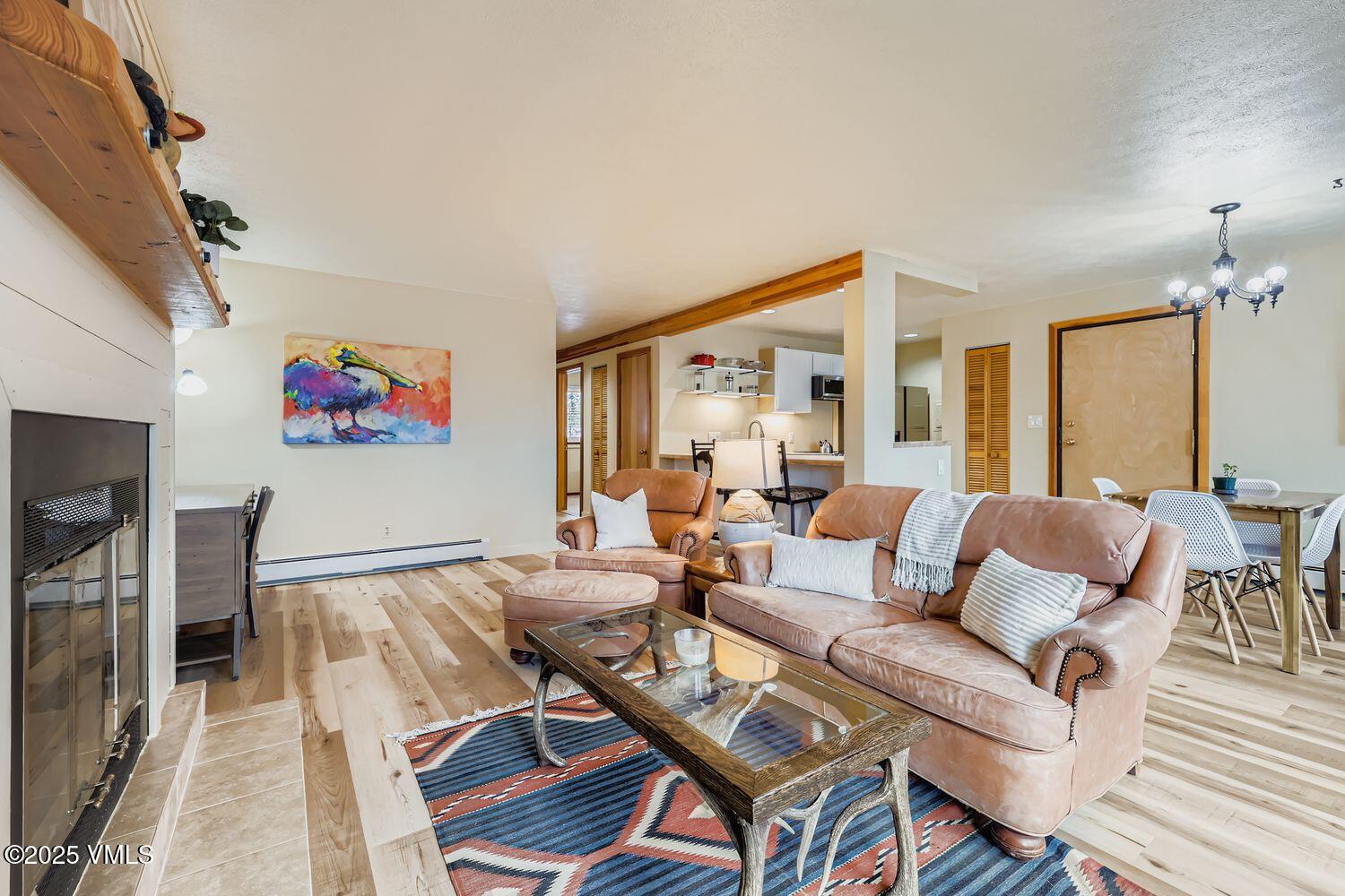 91300 Ryan Gulch Road, Unit 305 Silverthorne, CO 80498 - Photo 4 of 46 a living room with furniture a dining table and a piano table
