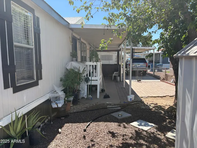 a view of a patio with table and chairs potted plants with wooden floor