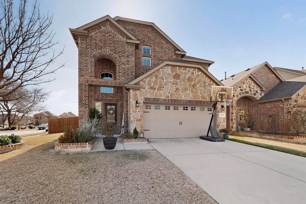 9801 Diamondback McKinney, TX 75071 - Photo 2 of 40 French provincial home with brick siding, driveway, stone siding, and an attached garage