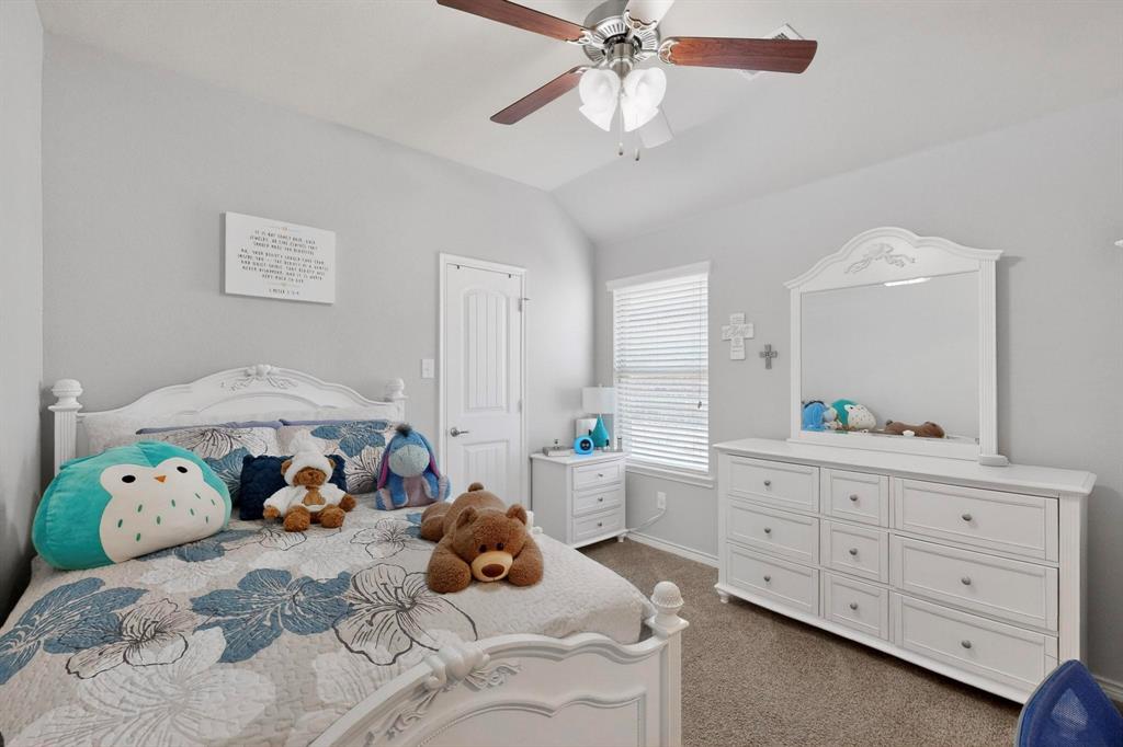 9801 Diamondback McKinney, TX 75071 - Photo 21 of 40 Bedroom with dark colored carpet, vaulted ceiling, and a ceiling fan