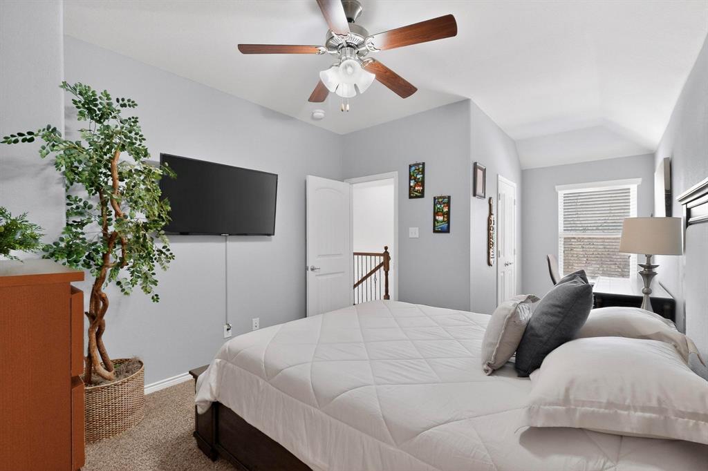 9801 Diamondback McKinney, TX 75071 - Photo 27 of 40 Bedroom with carpet floors, a ceiling fan, and vaulted ceiling