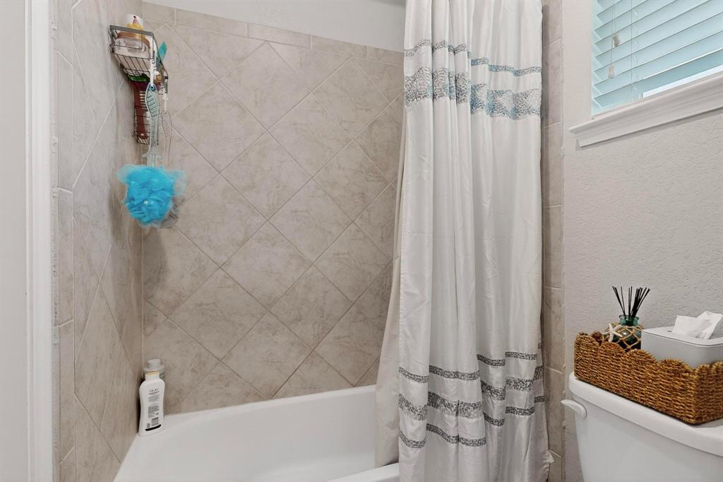 9801 Diamondback McKinney, TX 75071 - Photo 31 of 40 Full bathroom featuring shower / tub combo with curtain and toilet
