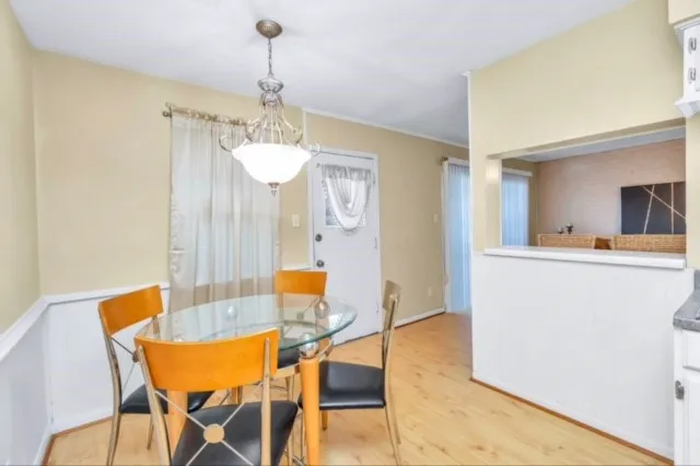 a view of a dining room with furniture and wooden floor