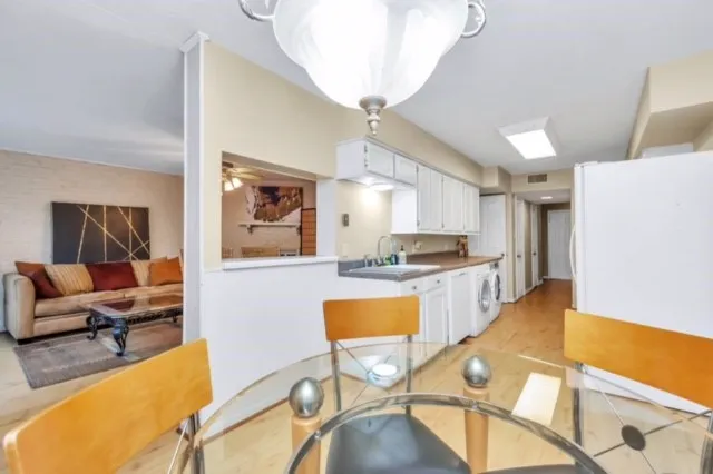 a large living room with stainless steel appliances kitchen island granite countertop furniture and a kitchen view