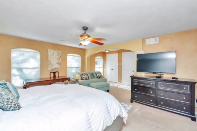 a bedroom with a bed and flat screen tv