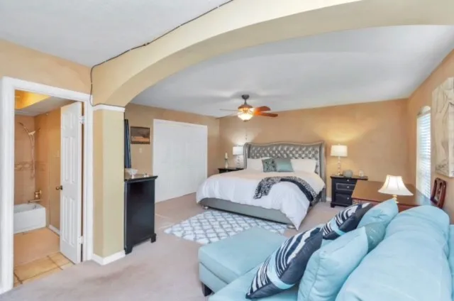 a bedroom with a bed and a chandelier