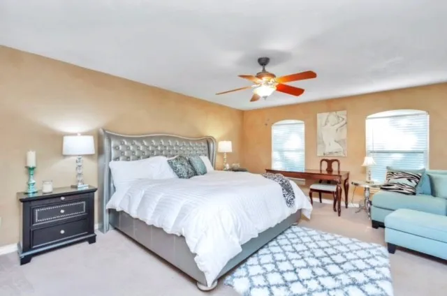 a bedroom with a bed and a chandelier