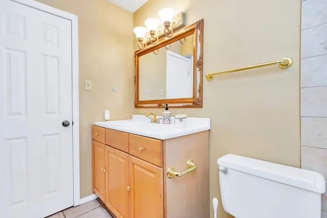 a bathroom with a sink a toilet and a mirror