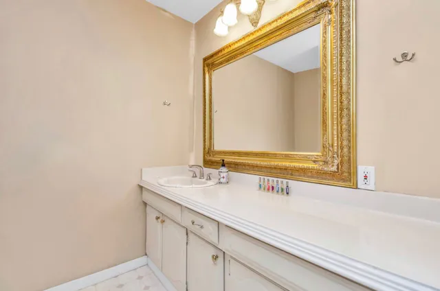a bathroom with a sink and a mirror