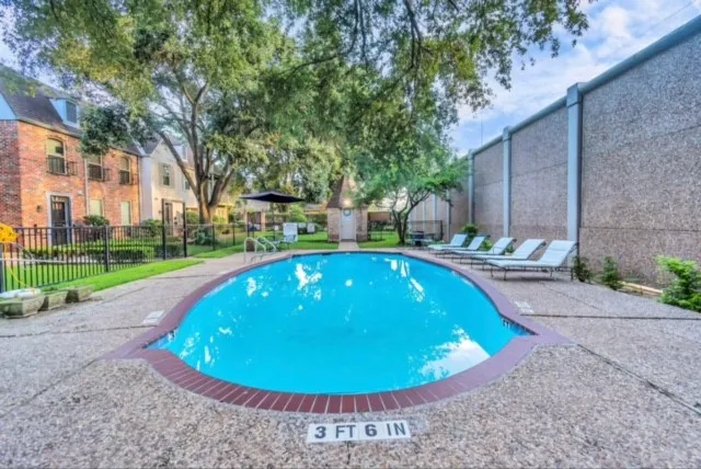 a view of a swimming pool with a yard