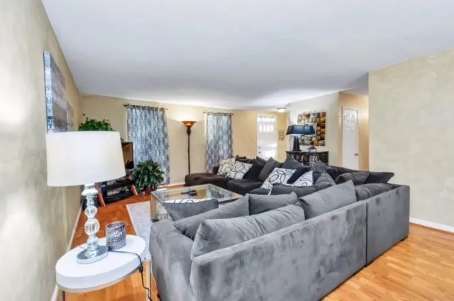 a living room with furniture and a lamp