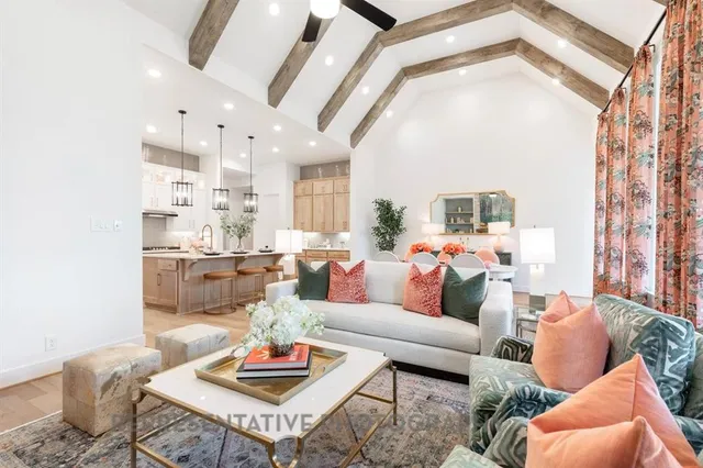 a living room with furniture fireplace and a large window