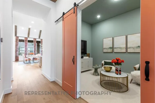 a view of a kitchen with white cabinets and entryway
