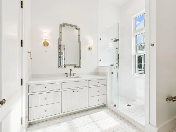 a bath room with closet and a shower