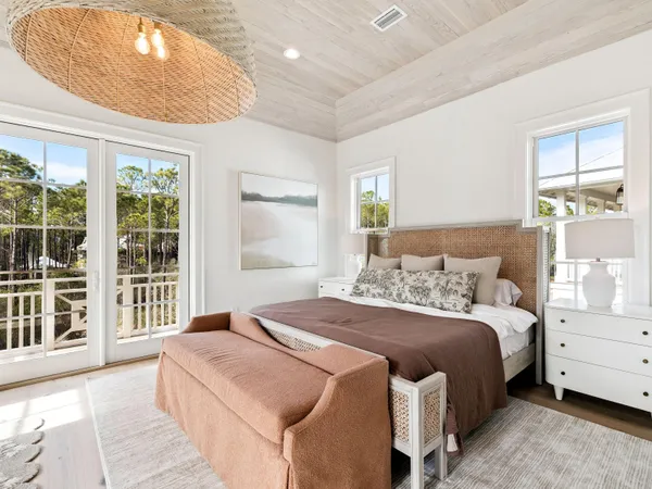 a bedroom with a large bed and a large window