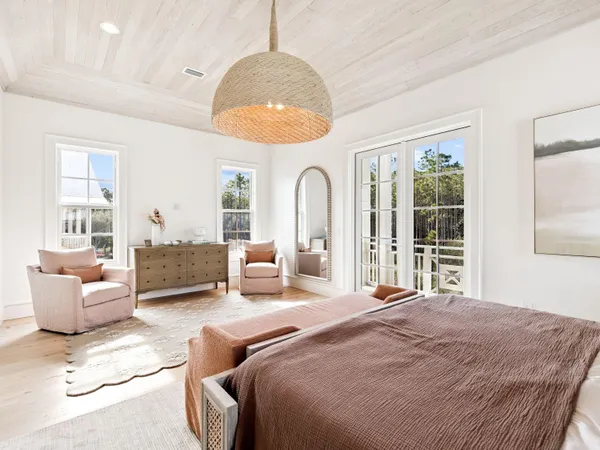 a spacious bedroom with a bed couch and window