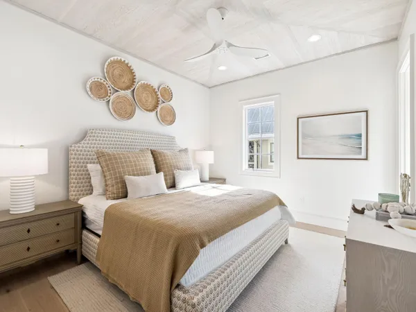a bedroom with a bed and a lamp on dresser
