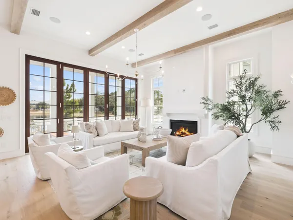 a living room with furniture a fireplace and a large window