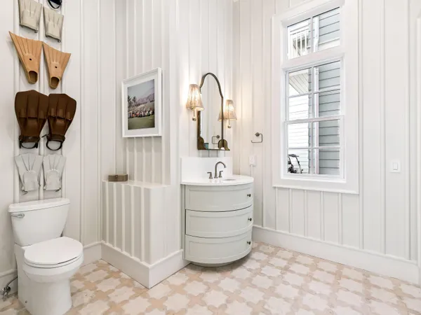 a bathroom with a toilet a sink and a window