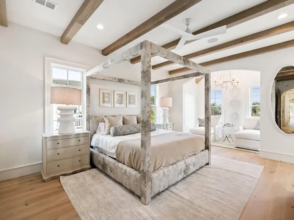 a bedroom with a large bed and a window
