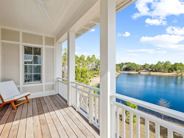 a view of a balcony with lake view and wooden floor