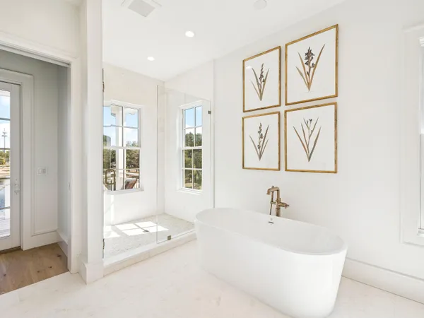 a white bath tub sitting next to a window