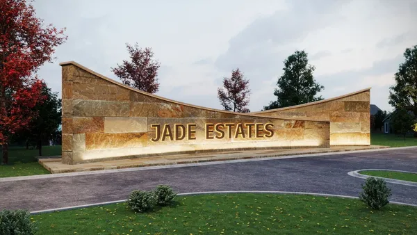 a sign that is sitting in front of house