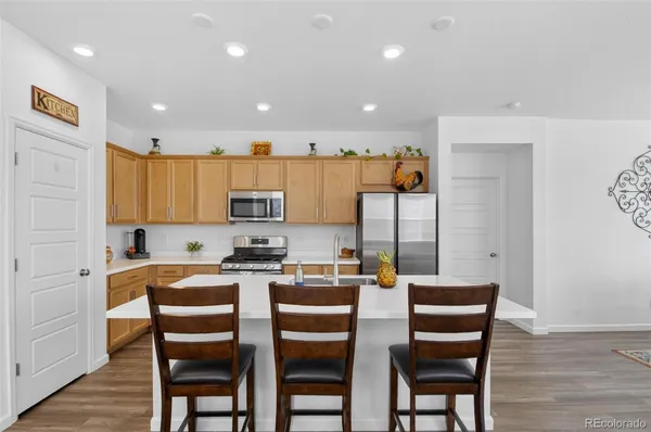 a kitchen that has a table and chairs in it