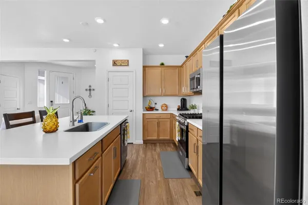 a kitchen with a sink appliances and cabinets