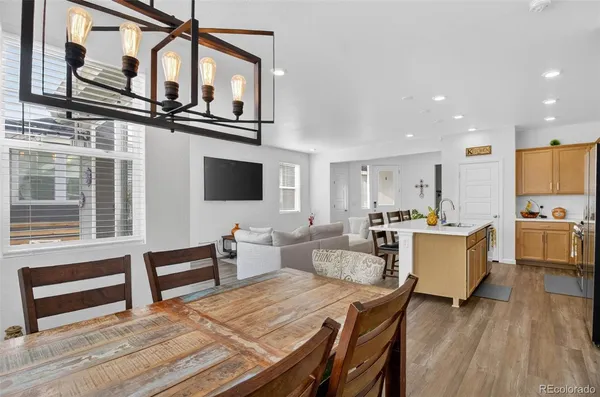 a living room with furniture a flat screen tv and kitchen view
