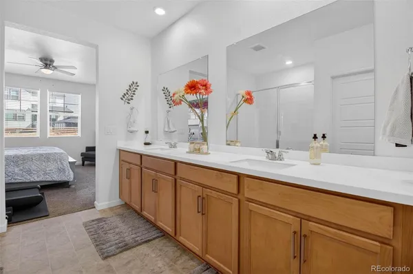 a bathroom with a double vanity sink a mirror and a bathtub