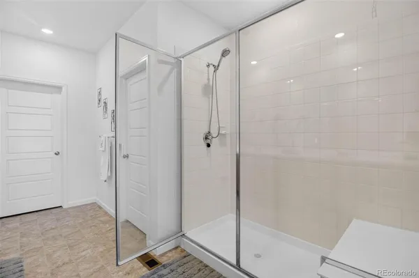 a bathroom with a shower and a glass door