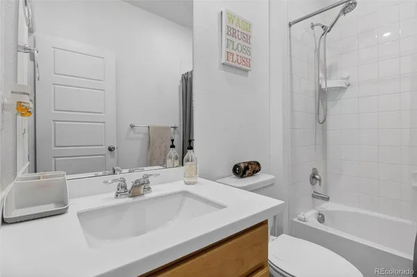 a bathroom with a sink toilet tub and shower