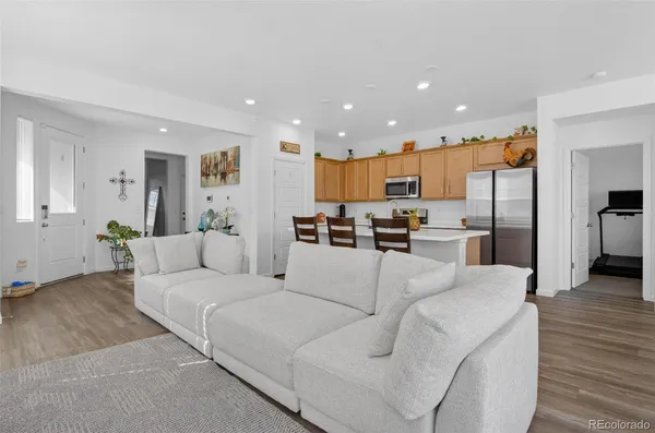 a living room with furniture and kitchen view