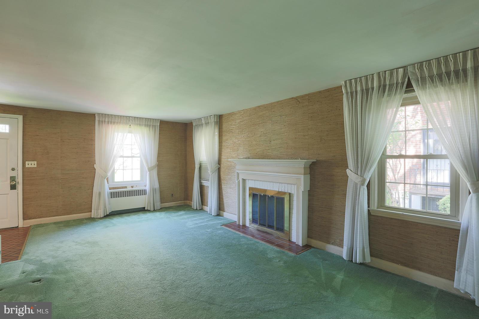 7005 Deerfield Road Pikesville, MD 21208 - Photo 12 of 30 Large living room has mirrored wall.
