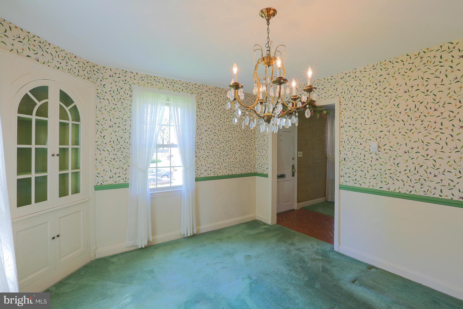 7005 Deerfield Road Pikesville, MD 21208 - Photo 10 of 30 Formal dining room carpet over wood.