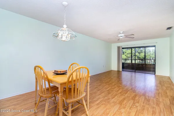 a view of a dining room with furniture wooden floor and chandelier