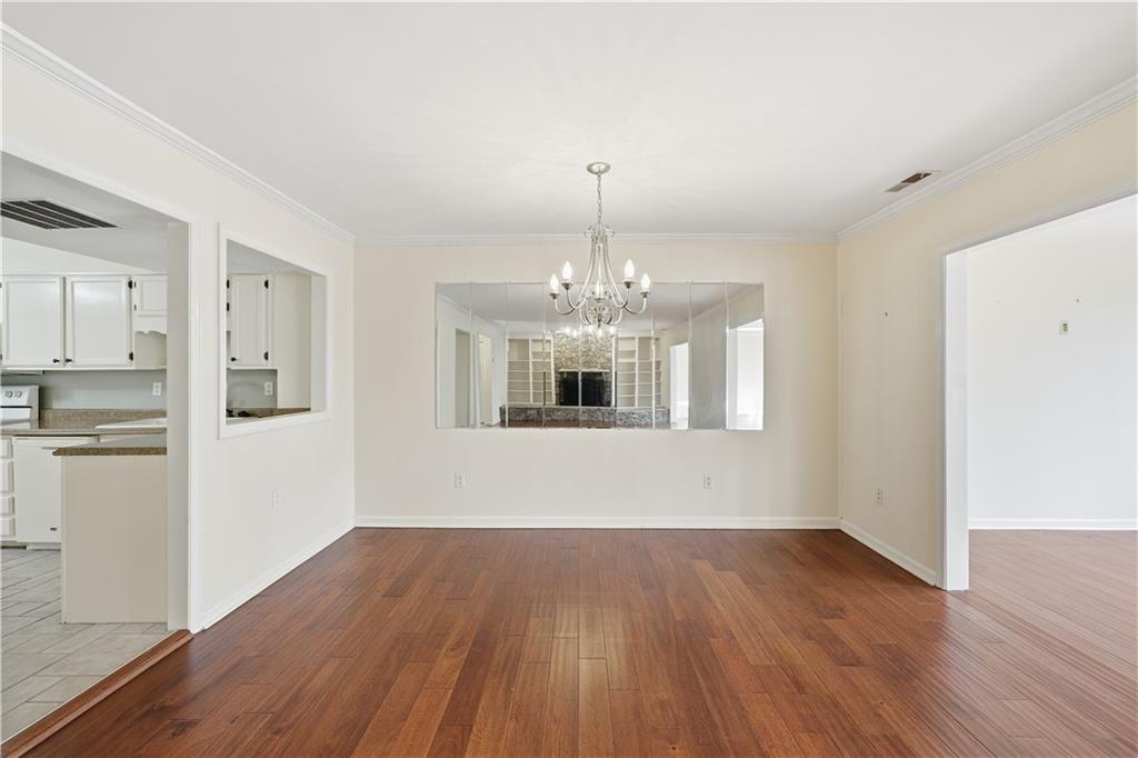 6500 Gaines Ferry Road, Unit I4 Flowery Branch, GA 30542 - Photo 14 of 29 a view of livingroom with kitchen and hardwood