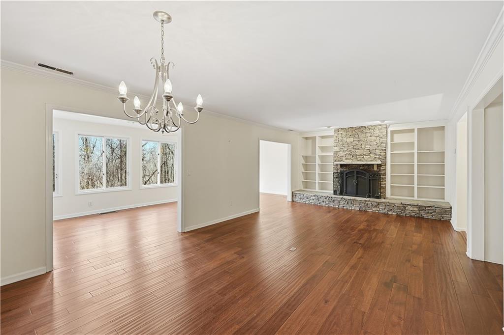 6500 Gaines Ferry Road, Unit I4 Flowery Branch, GA 30542 - Photo 16 of 29 a view of an empty room with wooden floor and a window