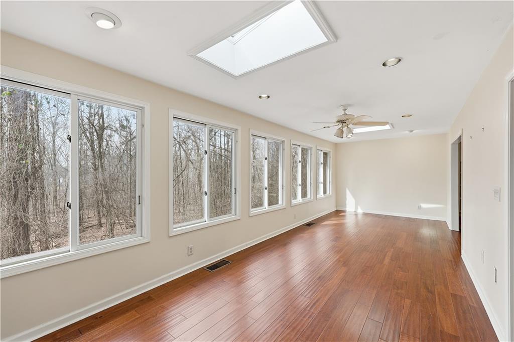 6500 Gaines Ferry Road, Unit I4 Flowery Branch, GA 30542 - Photo 18 of 29 a view of an empty room with wooden floor and a window