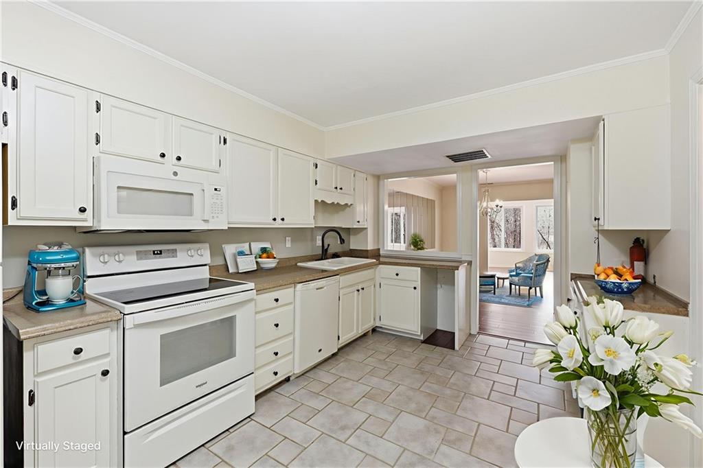 6500 Gaines Ferry Road, Unit I4 Flowery Branch, GA 30542 - Photo 19 of 29 a kitchen with white cabinets and white appliances