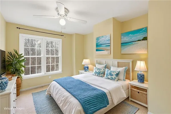 an empty room with windows and ceiling fan
