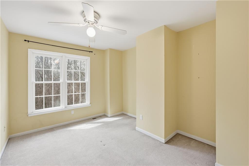 6500 Gaines Ferry Road, Unit I4 Flowery Branch, GA 30542 - Photo 23 of 29 an empty room with windows and ceiling fan